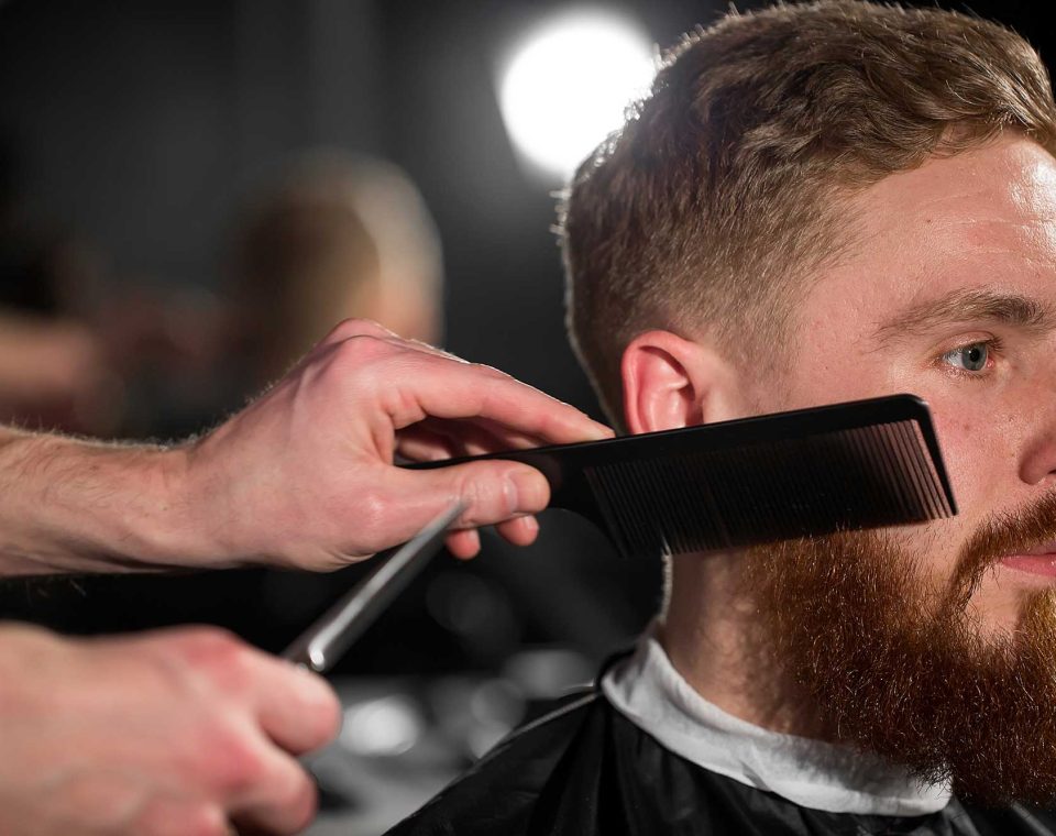 master-cuts-hair-and-beard-in-the-barber-shop-2022-02-12-05-54-49-utc